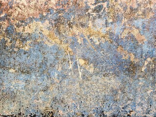 Fototapeta premium Grungy textured background of an aged wall with peeling blue paint, rust stains, and weathered concrete, perfect for industrial designs, vintage overlays, and urban backgrounds