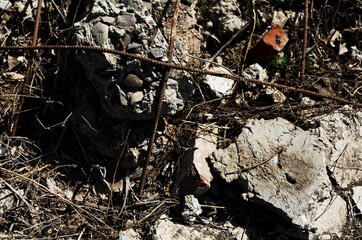 Urban Decay: Crumbled Concrete and Rusty Reinforcement Bars in Grunge Construction Site Close-up