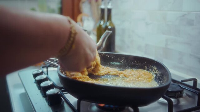 Close up of kuymak, a traditional Turkish dish made with melted cheese, cornmeal, and butter, cooked hot in a pan.
