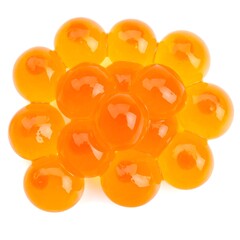 A pile of translucent orange gel balls, clustered closely on a white background