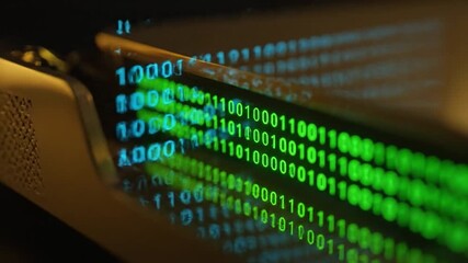 Reflective surface displaying a stream of vibrant green binary code, depicting complex digital information - Powered by Adobe