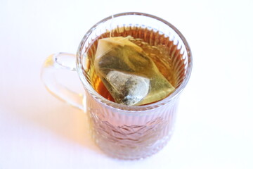 A woman in a path in winter. Forest with snow and someone walking. Hiking and trail in winter and outdoor activities. Relaxing in the forest in winter.