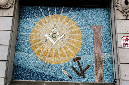 Masonic Symbols On Building Wall: Mosaic Artwork Displaying Square And Compass, Sun And Tools In Urban Setting, Boston MA