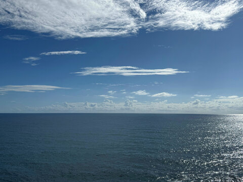 Calm ocean blue glittering waters and sky.
