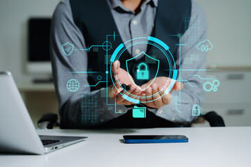 Cybersecurity and privacy concepts to protect data. Lock icon and network security technology. Man protecting personal data on smartphone tablet, virtual screen interfaces. In office