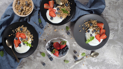 Ripe blueberries and strawberries with yogurt and granola