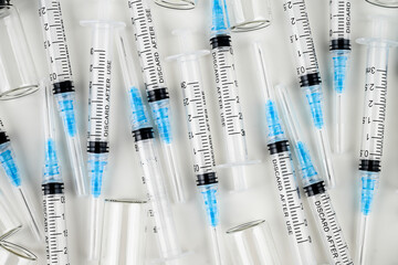 Single Use Syringes with Needles on White Background