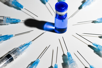 Single Use Syringes With Needles and Vial With Copper Peptides on White Background