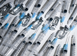 Single Use Syringes with Needles on White Background