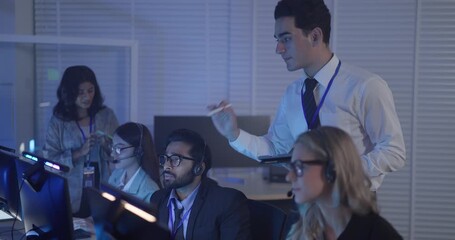 A focused team wearing headsets monitors live analytics dashboards and collaborates in modern control room. Highlighting customer support, data driven decision making, coordinated incident response.
 - Powered by Adobe