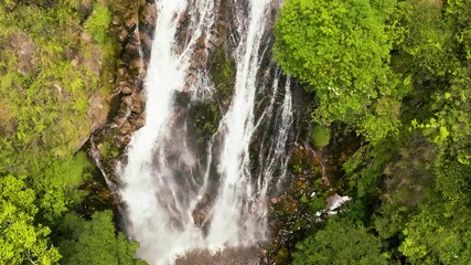 Top view of beautiful Efrata waterfall in the mountains in slow motion. Samosir, Indonesia.