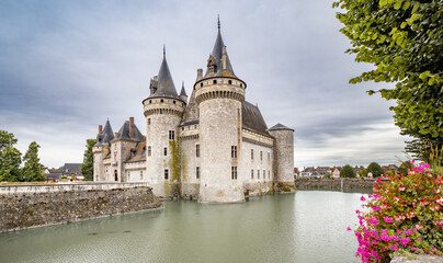 Medieval Castle with Towers Surrounded by Moat in France.