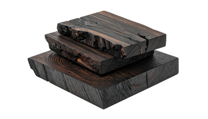 Stack of dark wooden blocks with rough edges, against black