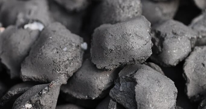 charcoal compressed from crumbs is obtained under pressure and used to light a fire , black charcoal in briquettes for barbecues and grills