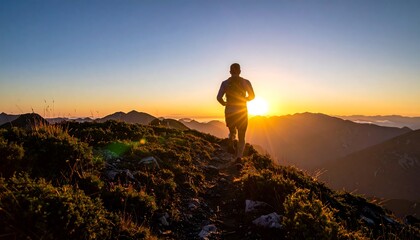 Fototapeta premium Man Running on Mountain Ridge at Sunrise for Fitness.