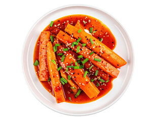 Overhead shot of glazed carrot sticks sprinkled with sesame seeds on a plate