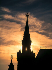Sunset sun peaking through historic tower silhouette of State Historical Museum at Red Square in Moscow, Russia. 