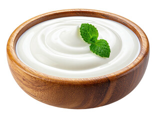 Close-up of creamy, white dairy product in a wooden bowl with a sprig of green