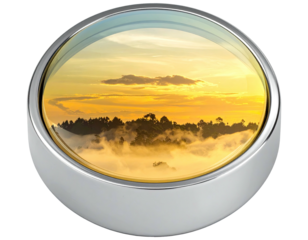 Round metallic window frames a vibrant sunrise mountain landscape