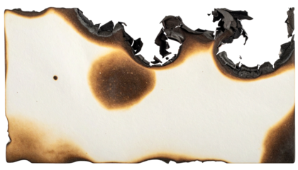 Close-up of a white paper with charred edges and brown patches