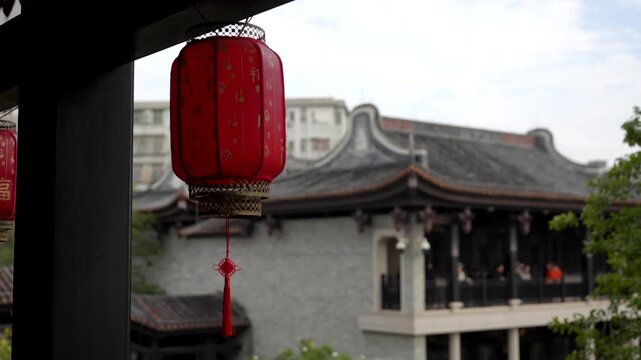 Traditional red Chinese lantern with historic architecture in the background in Yongqing Fang, a cultural district combining restored heritage buildings and modern urban spaces in Guangzhou.