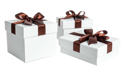 Three white gift boxes with brown ribbons, stacked and arranged