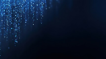 Bright sparkling blue particles falling against a dark background creating a beautiful abstract pattern with a sense of depth and motion for artistic use