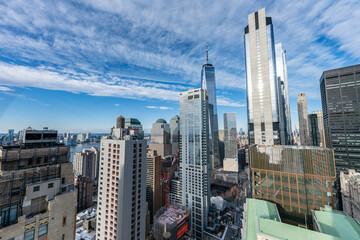 Obraz premium New York City skyline with One World Trade Center and East River under blue sky