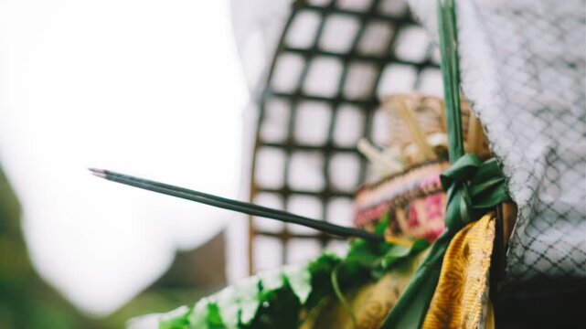 Balinese Canang Sari Offering with Burning Incense and Smoke