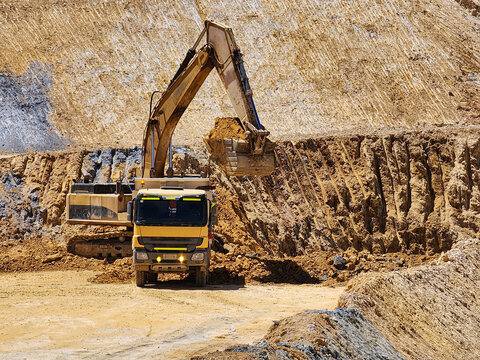 Excavation and embankment formation process using heavy construction machinery