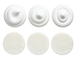 Six white circles of textured cream atop of light-colored cotton pads