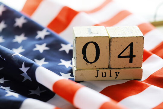 July 4th wooden Stars and Stripes flag on background with flag of the USA. Summer day. Independence Day Of America
