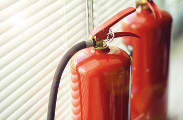 Fire extinguisher has hand engineer inspection checking pressure gauges to prepare fire equipment for protection and prevent emergency and safety rescue and alarm system training concept.