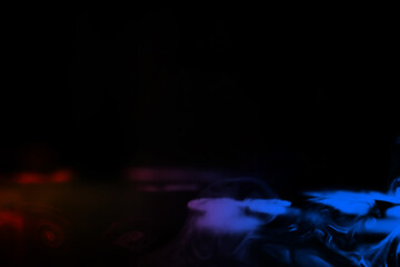 Fototapeta premium colorful smoke on dark background. Color steam on a black background. Red and blue smoke. Copy space.