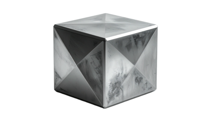 A textured metallic cube with geometric panels against black