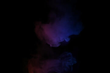 colorful smoke on dark background. Color steam on a black background. Red and blue smoke. Copy space.