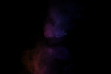 colorful smoke on dark background. Color steam on a black background. Red and blue smoke. Copy space.