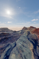Fototapeta premium Dramatic Desert Ridge Under Bright Sun With Rugged Rock Formations and Expansive Sky Above Horizon