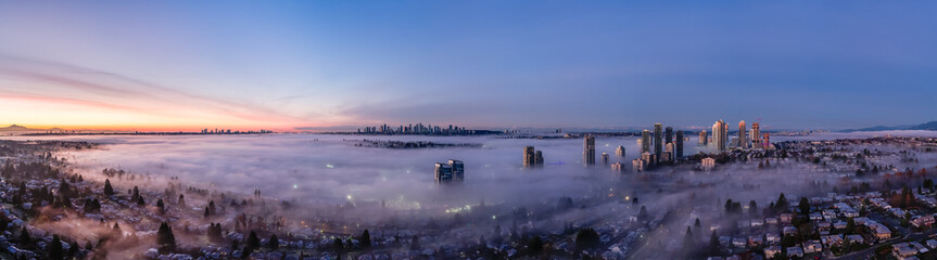 Panoramic Sunrise Over Burnaby Skyline Shrouded in Fog With Vancouver Horizon