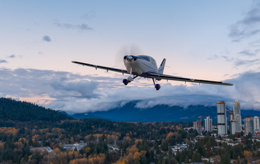 Fototapeta premium 3D Rendering Airplane Flying Over Sunset Cityscape With Autumn Trees In Burnaby, BC