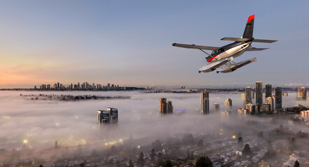 Seaplane Flying Over Foggy Cityscape at Sunrise Above Vancouver Harbor