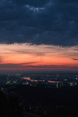 Fototapeta premium A colorful sunrise sky with clouds over the city with a river. The rising sun