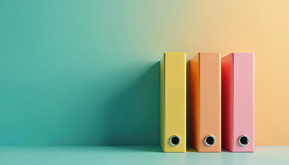 Three colorful binders stand on shelf against two tone wall. Yellow, orange, pink office supplies organize paperwork. Clean background for modern business or education themes.