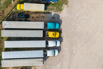 Top down view of colorful semi-trucks with white trailers . © SNEHIT PHOTO