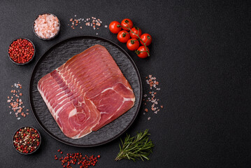 Naklejka premium Meat, ham, jamon, or prosciutto sliced for breakfast bruschetta. Sliced ham, jamon, or prosciutto
