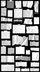 Assorted collection of torn, crumpled, and taped white paper scraps arranged on a stark black background