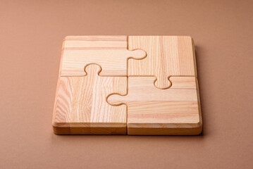 A wooden empty puzzle piece for a sign or business concept. A wooden empty puzzle