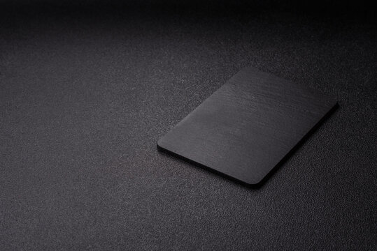 A black slate stone board or plate, an empty kitchen utensil. A black slate board