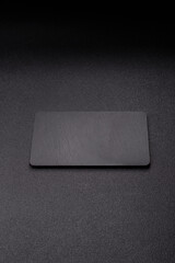A black slate stone board or plate, an empty kitchen utensil. A black slate board © chernikovatv