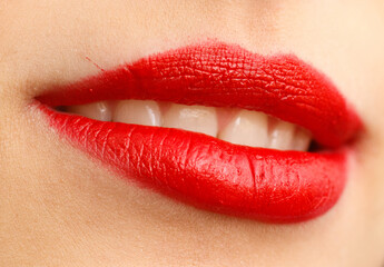 A woman's lips are red and she is smiling